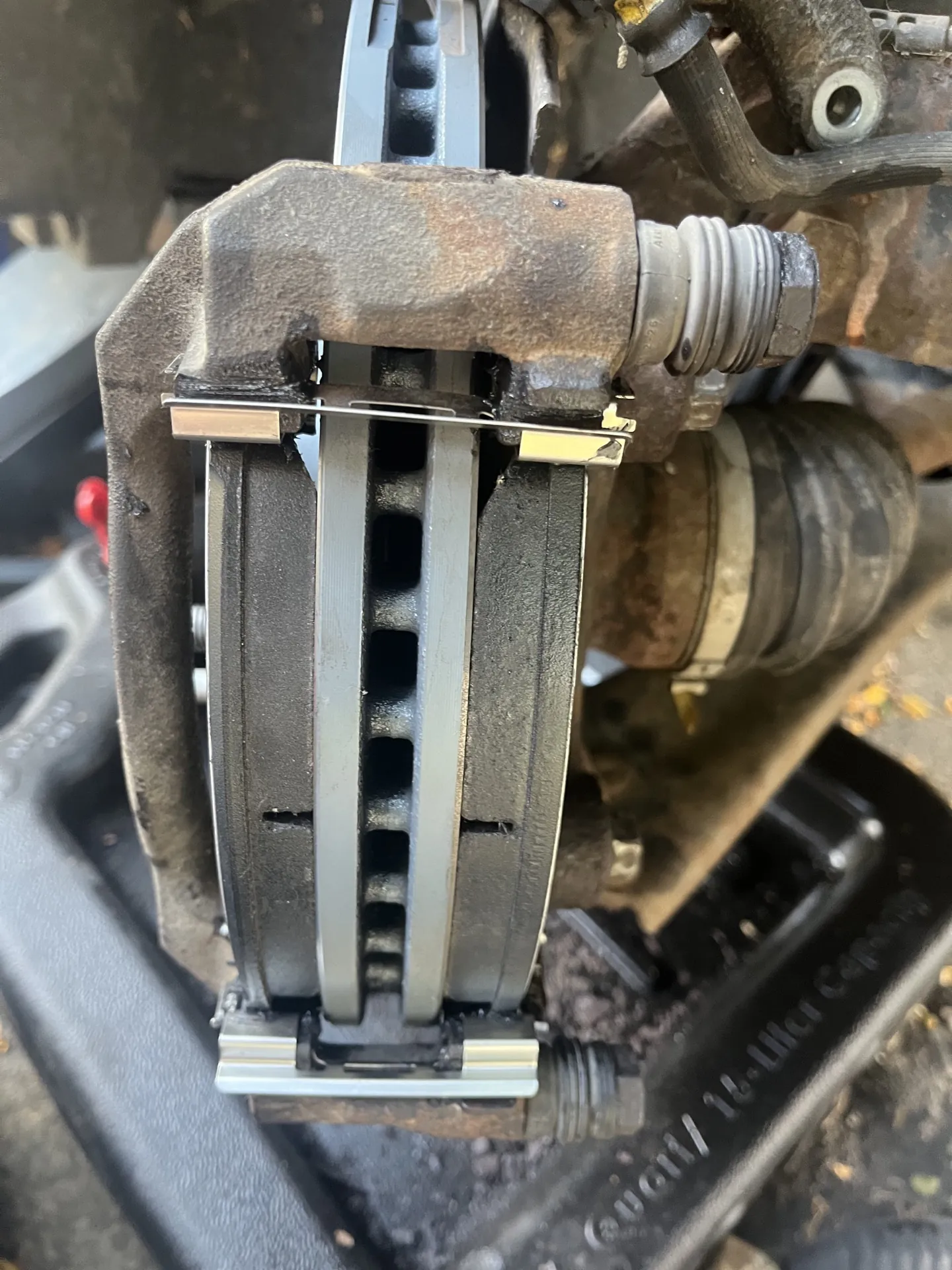 Close view of brake pads and a rotor being serviced by Wayne's Mobile Mechanic