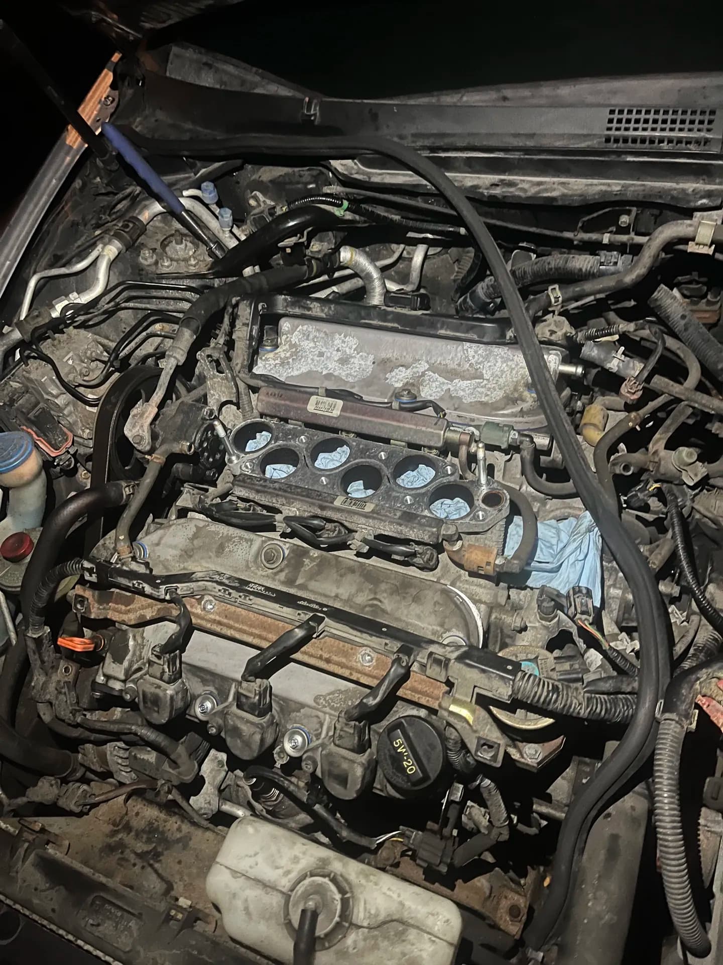 Engine tune-up in progress with ignition components accessible